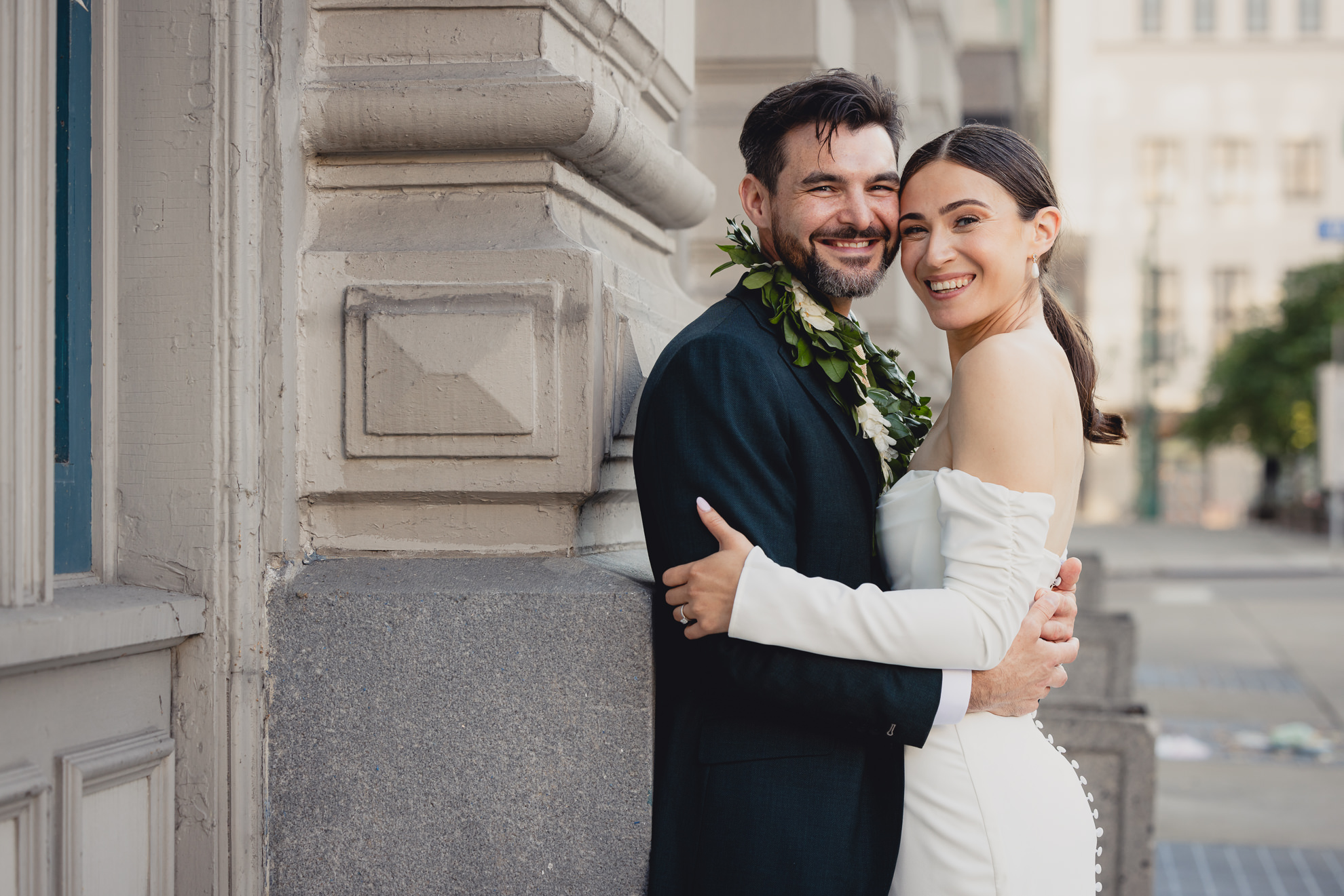bride and groom pose for portrait in downtown Buffalo, NY after wedding ceremony