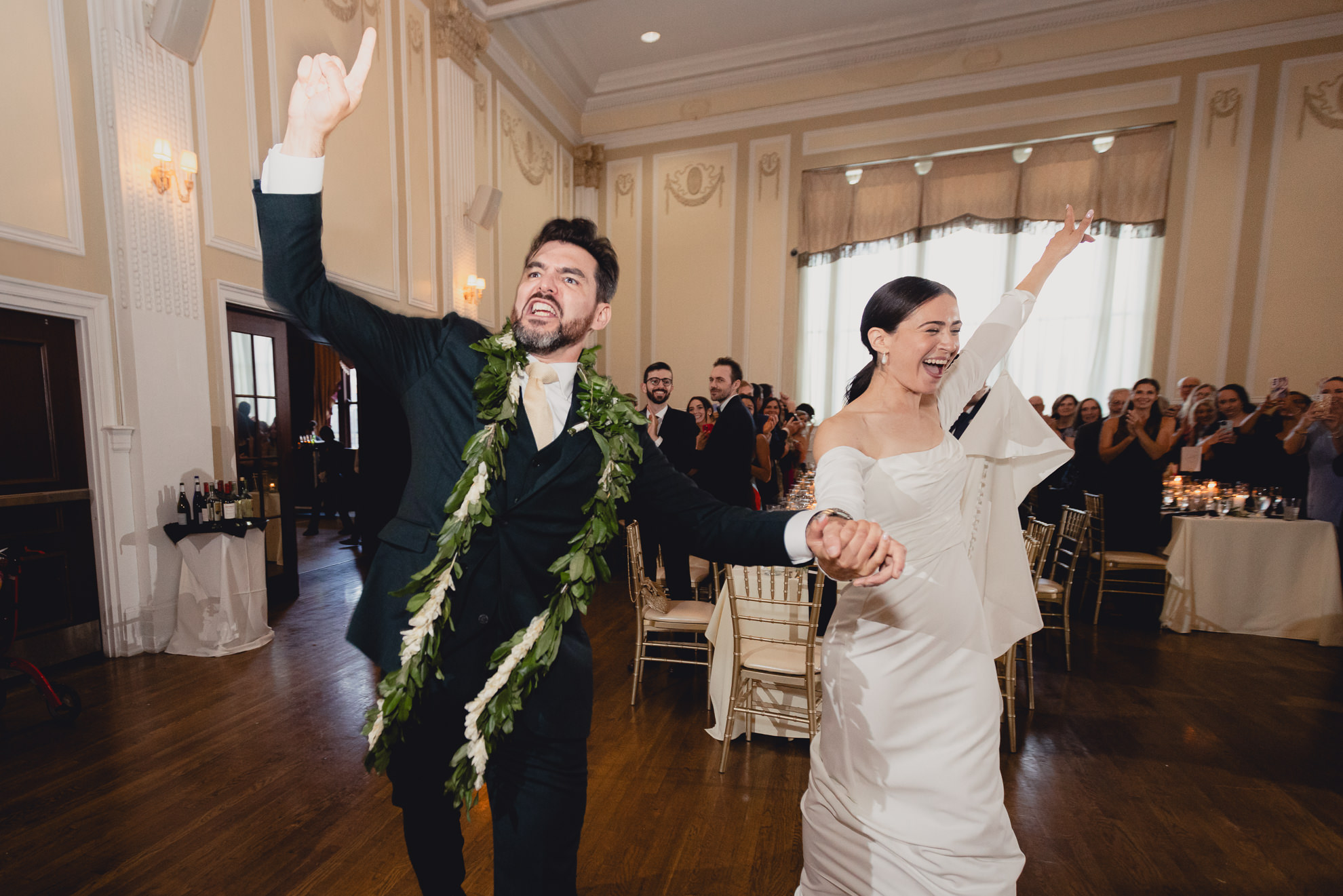 bride and groom cheer as they're being introduced during wedding reception at the Hotel Lafayette in Buffalo, NY