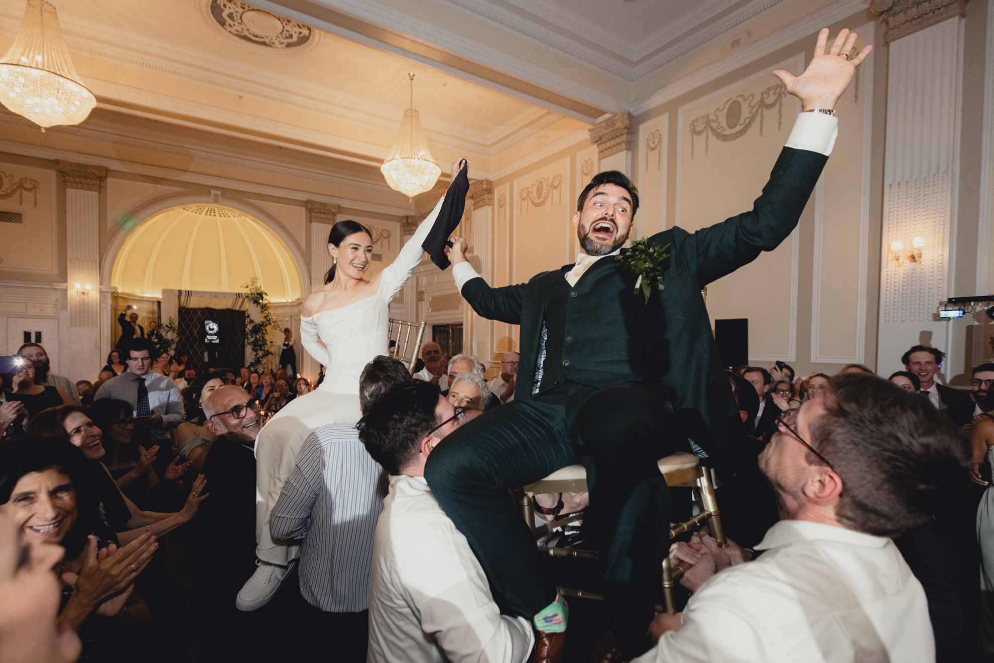bride and groom lifted on chairs during hava nagila during wedding reception at the Hotel Lafayette in Buffalo, NY