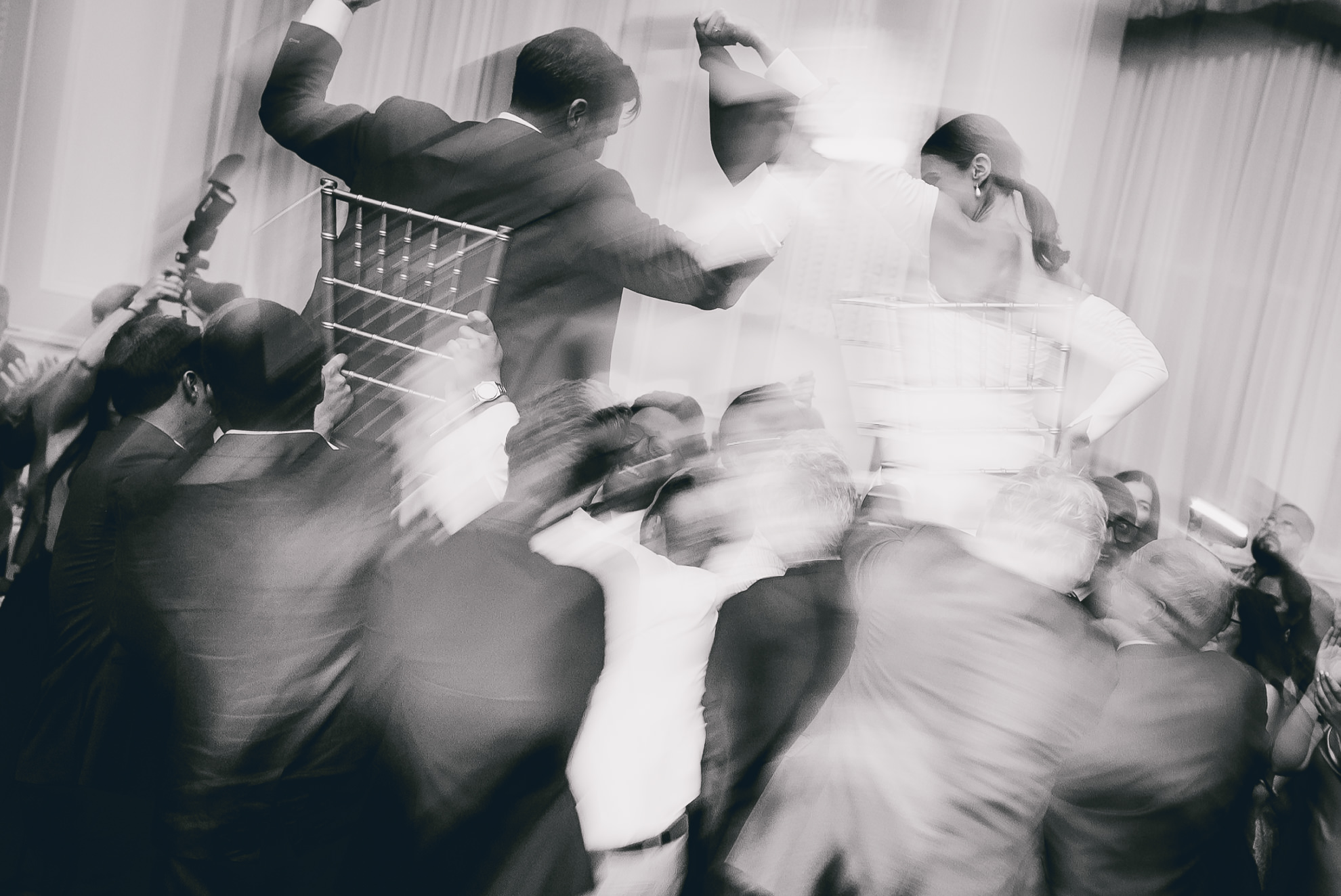 bride and groom lifted on chairs during hava nagila during wedding reception at the Hotel Lafayette in Buffalo, NY
