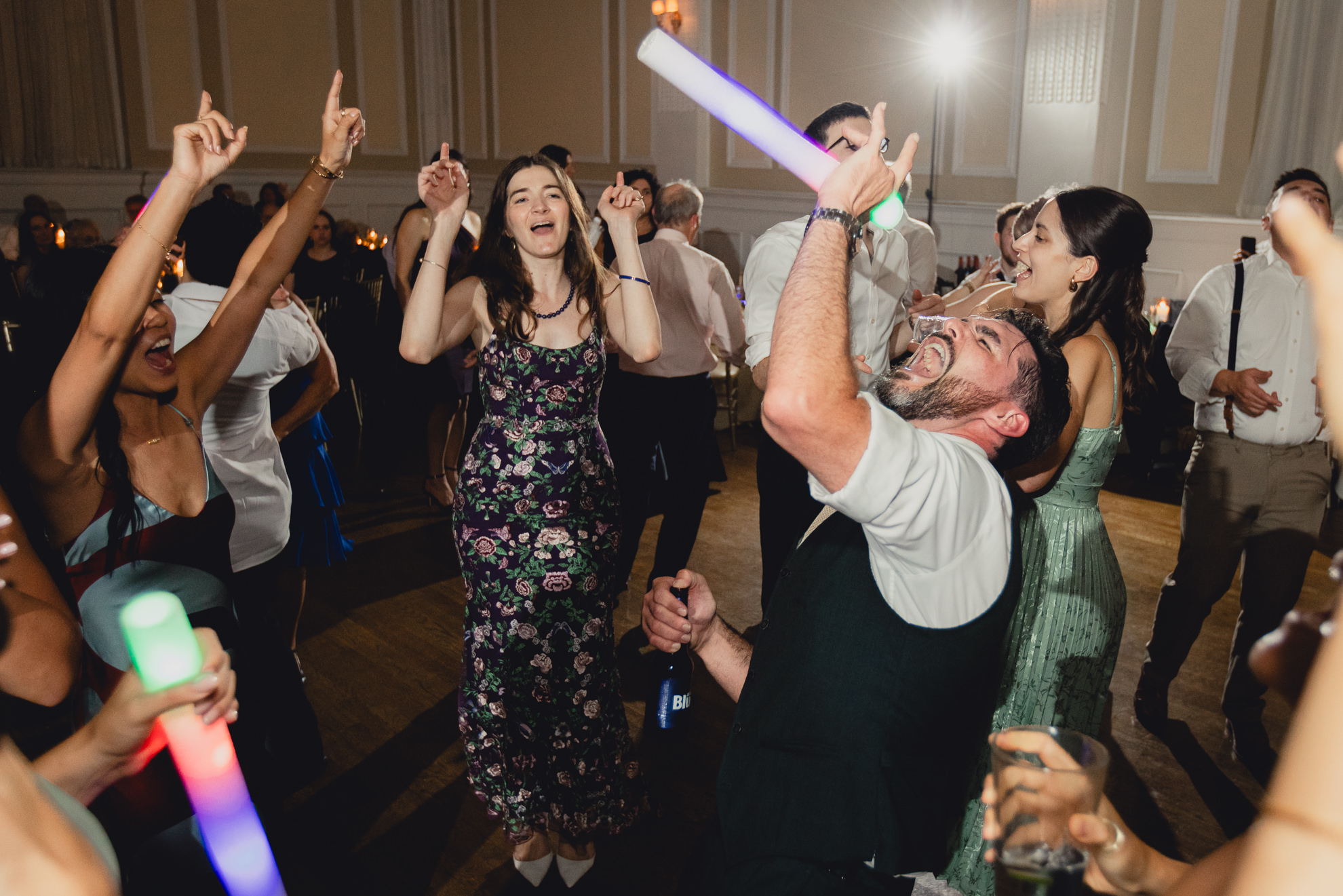groom sings into glow stick during wedding reception at the Hotel Lafayette in Buffalo, NY