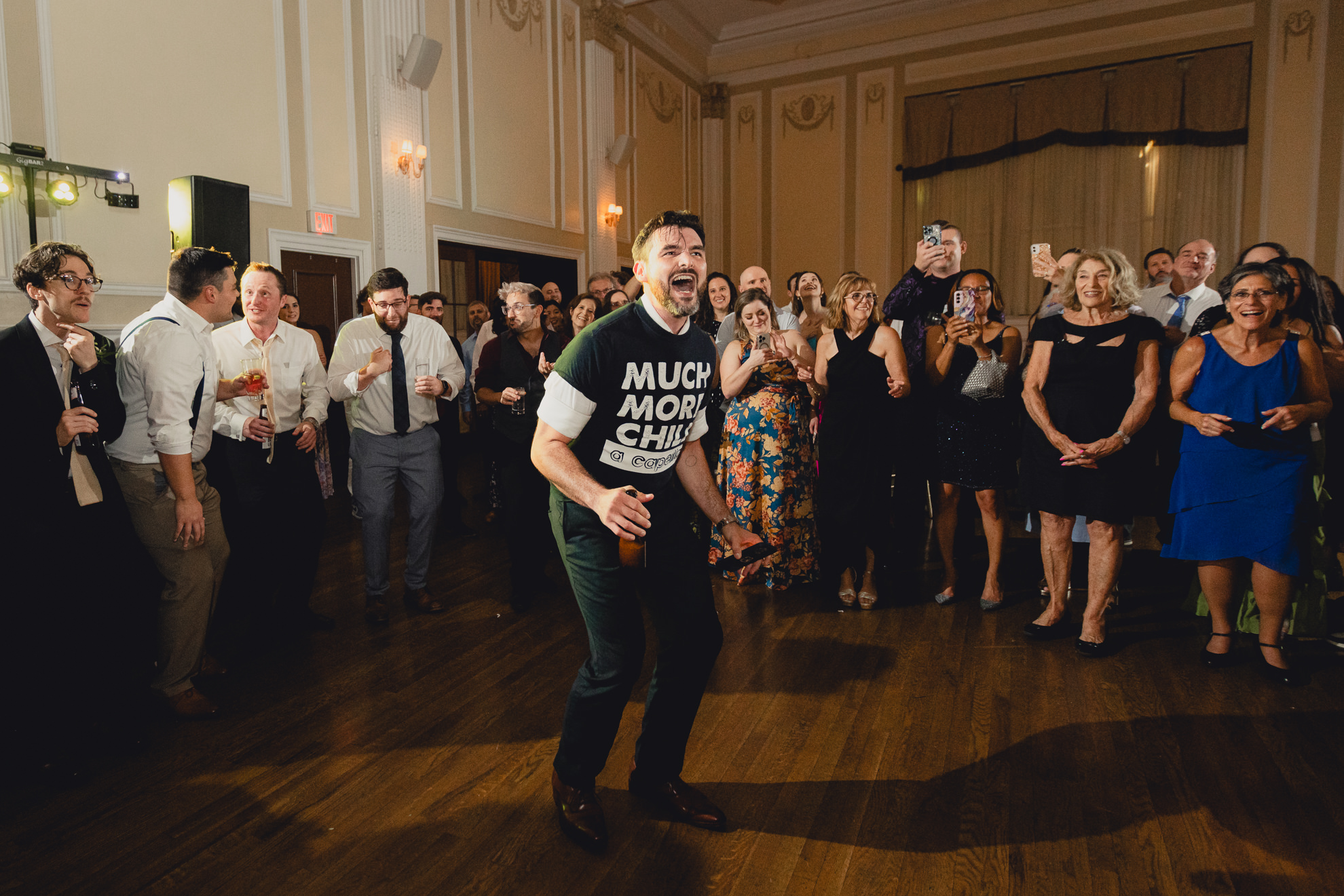 groom sings with a capella group during wedding reception at the Hotel Lafayette in Buffalo, NY