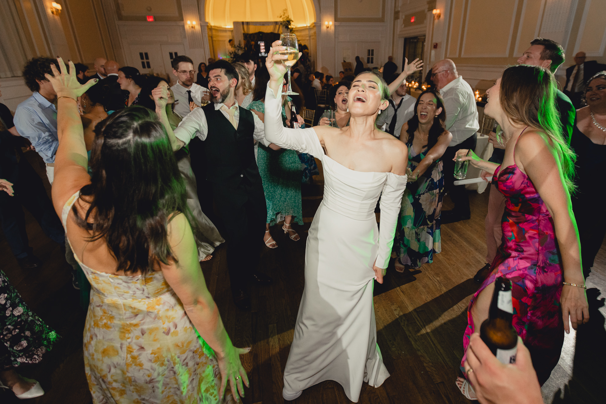 bride sings with glass of wine in hand during wedding reception at the Hotel Lafayette in Buffalo, NY