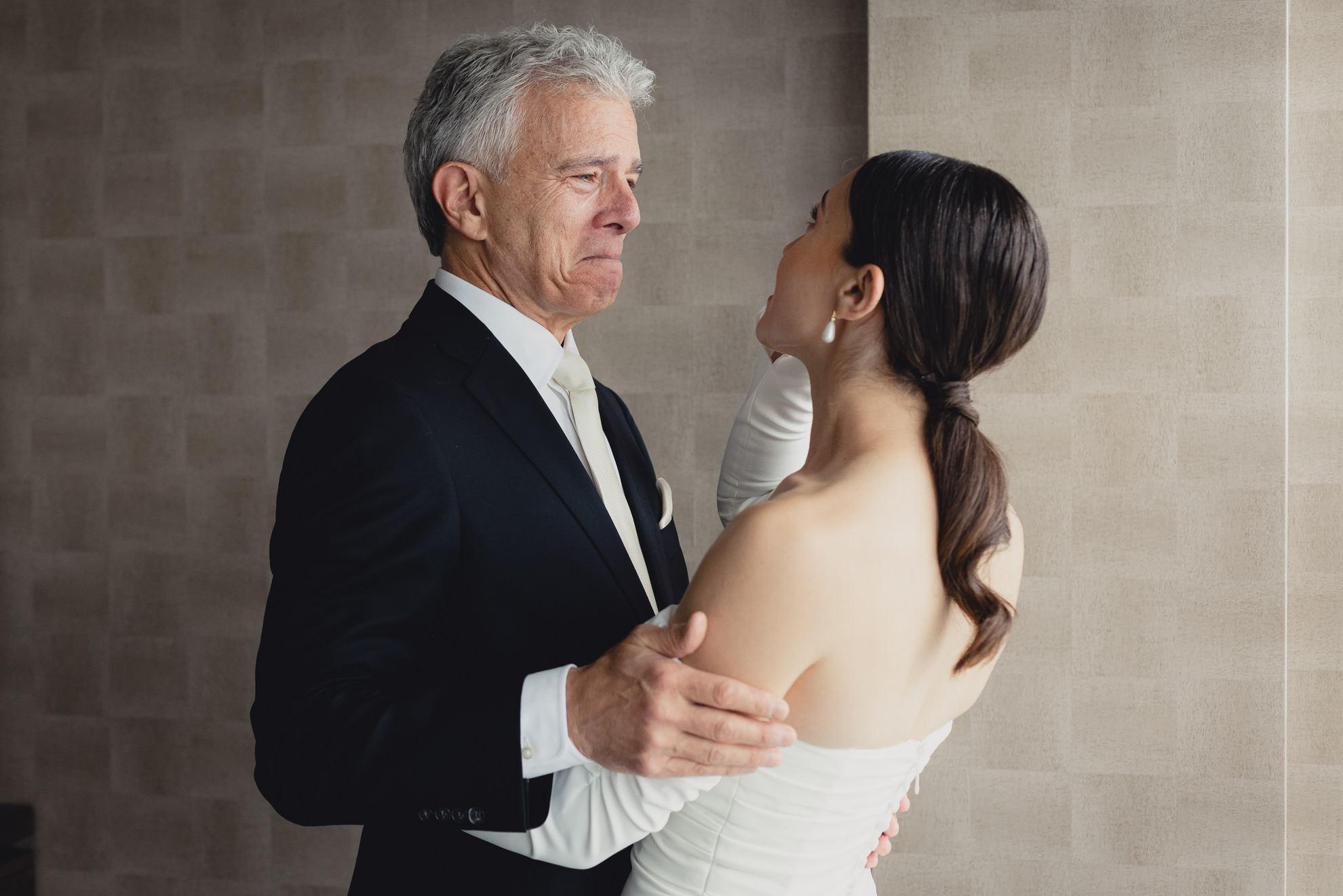 bride and dad cry after first look in hotel room at Marriott Lecom Harborcenter in Buffalo, NY
