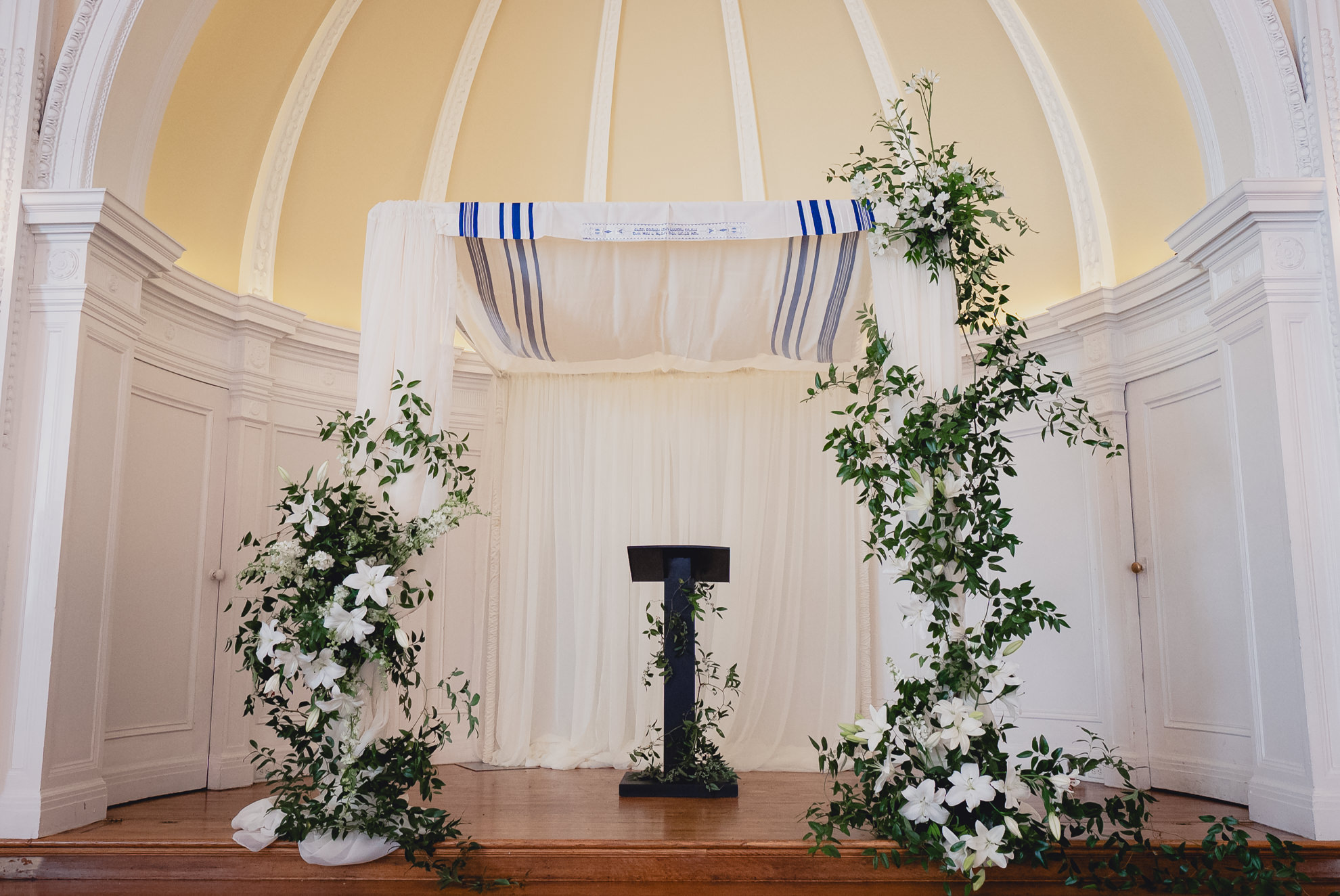 chutzpah adorned with white lilies seen before wedding ceremony in the Golden Ballroom of the Hotel Lafayette