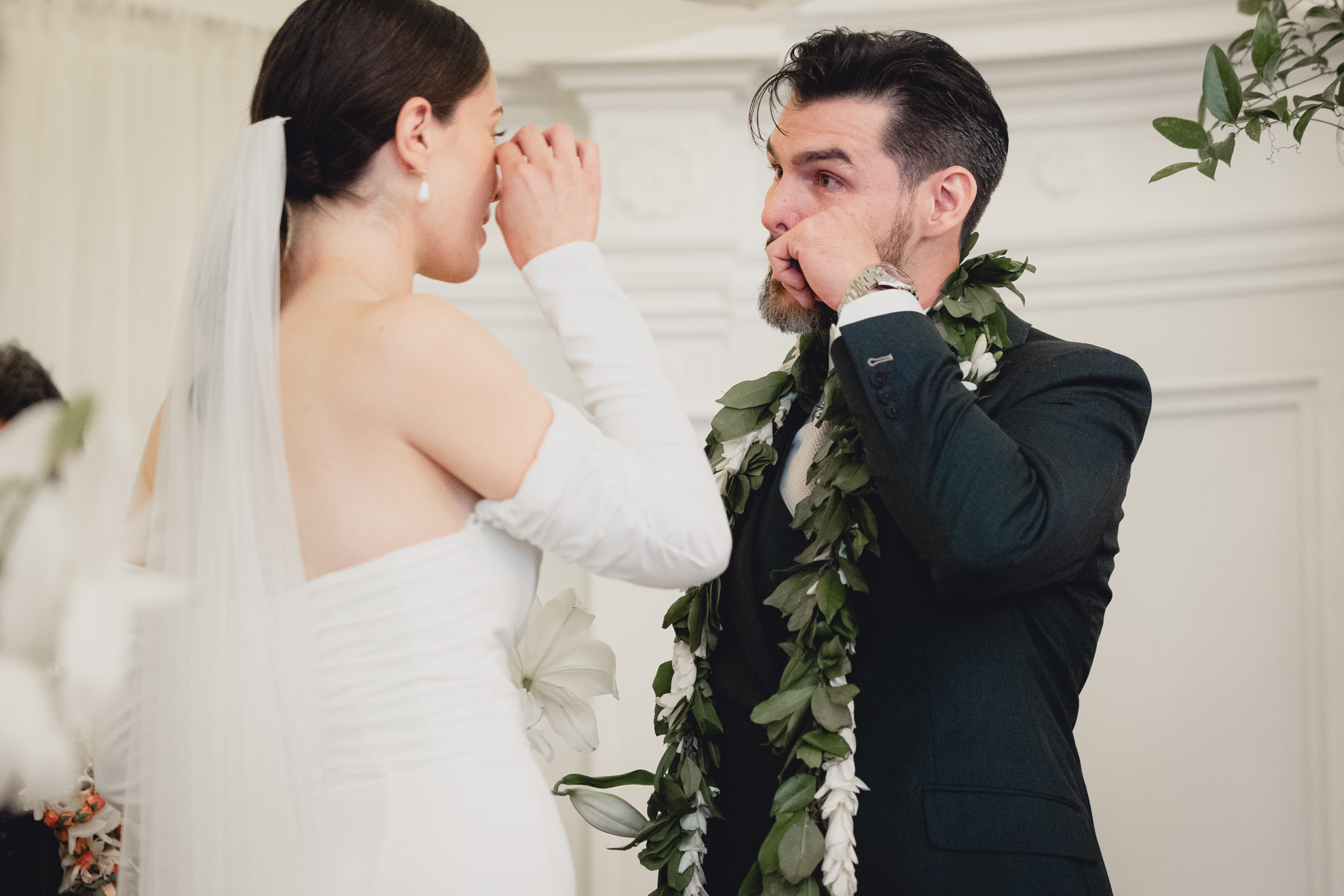 bride and groom wipe tears during wedding ceremony in the Golden Ballroom of the Hotel Lafayette