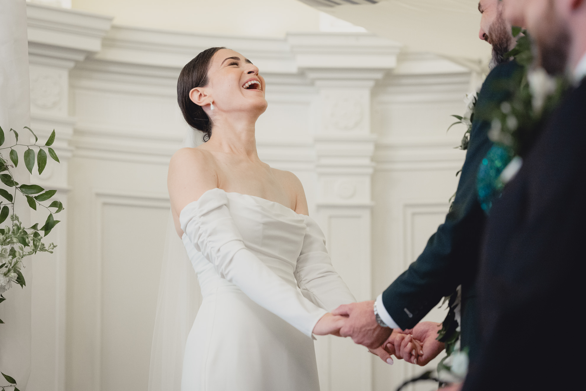 bride laughs during wedding ceremony in the Golden Ballroom of the Hotel Lafayette