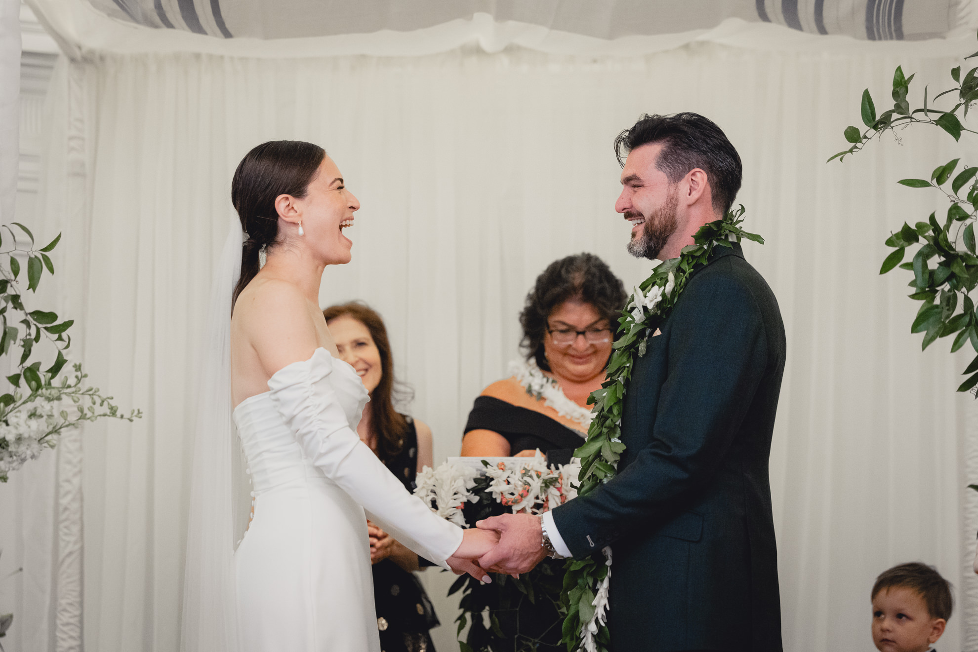 bride and groom laugh during wedding ceremony in the Golden Ballroom of the Hotel Lafayette