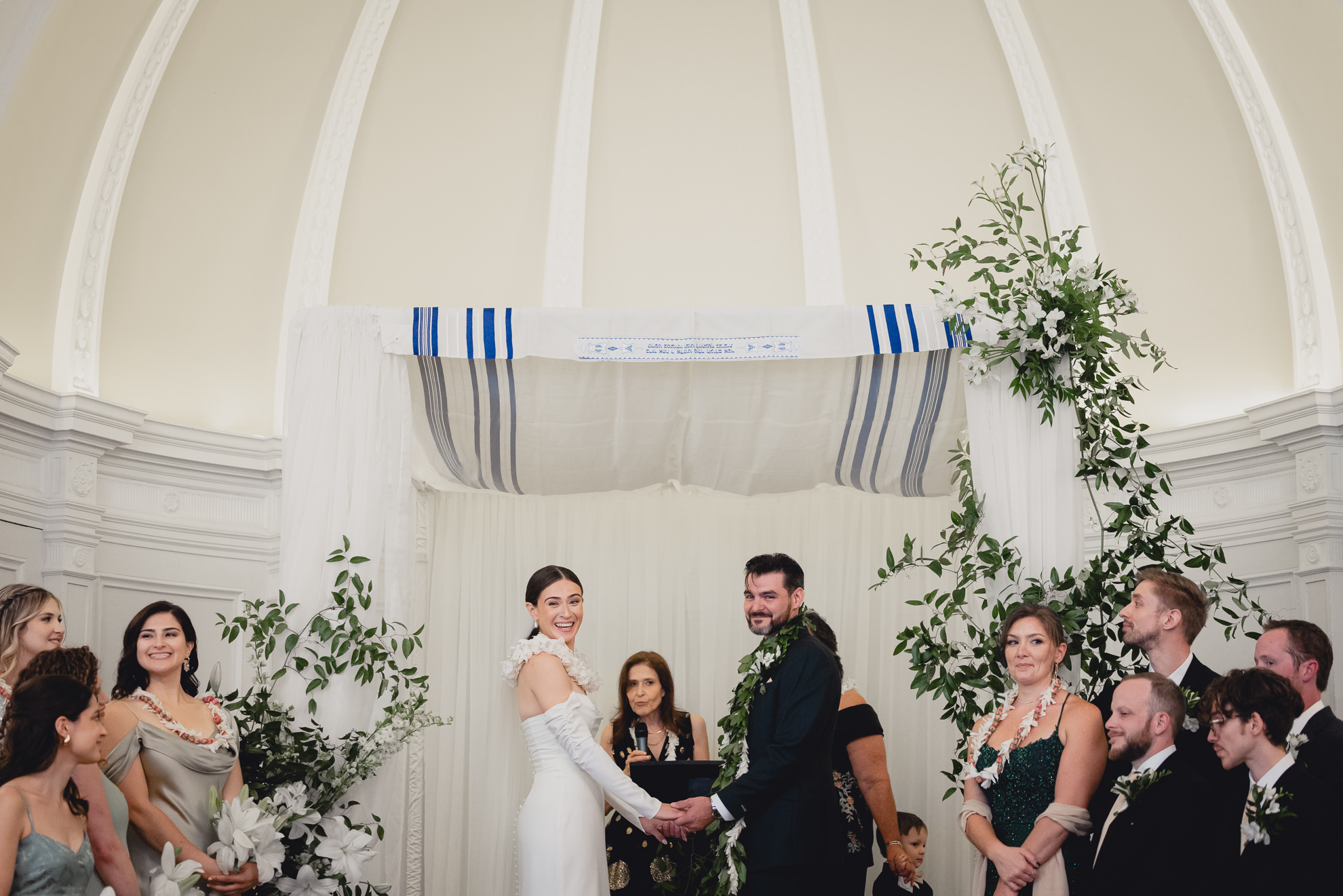 bride and groom look out at guests during wedding ceremony in the Golden Ballroom of the Hotel Lafayette