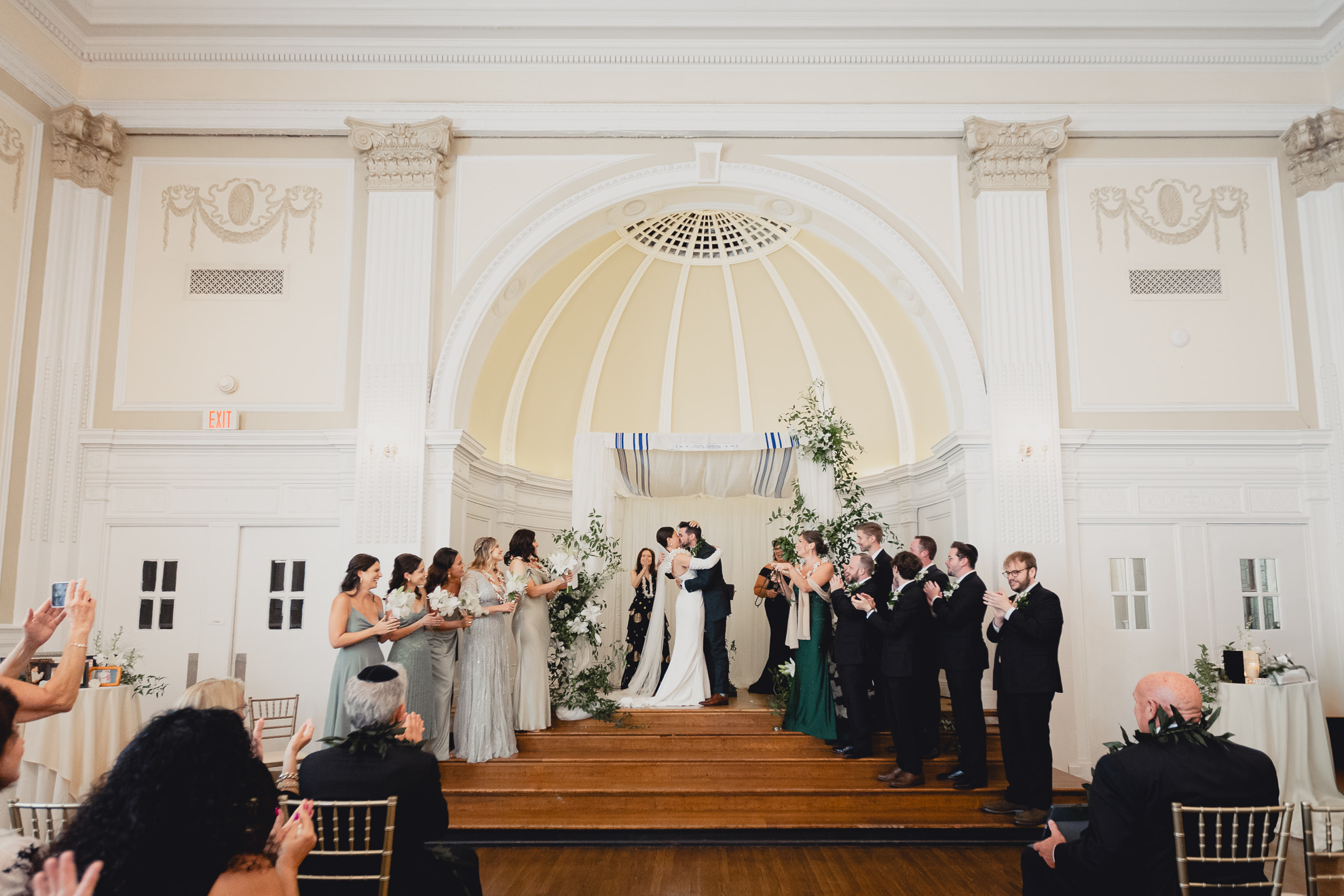 bride and groom kiss during wedding ceremony in the Golden Ballroom of the Hotel Lafayette