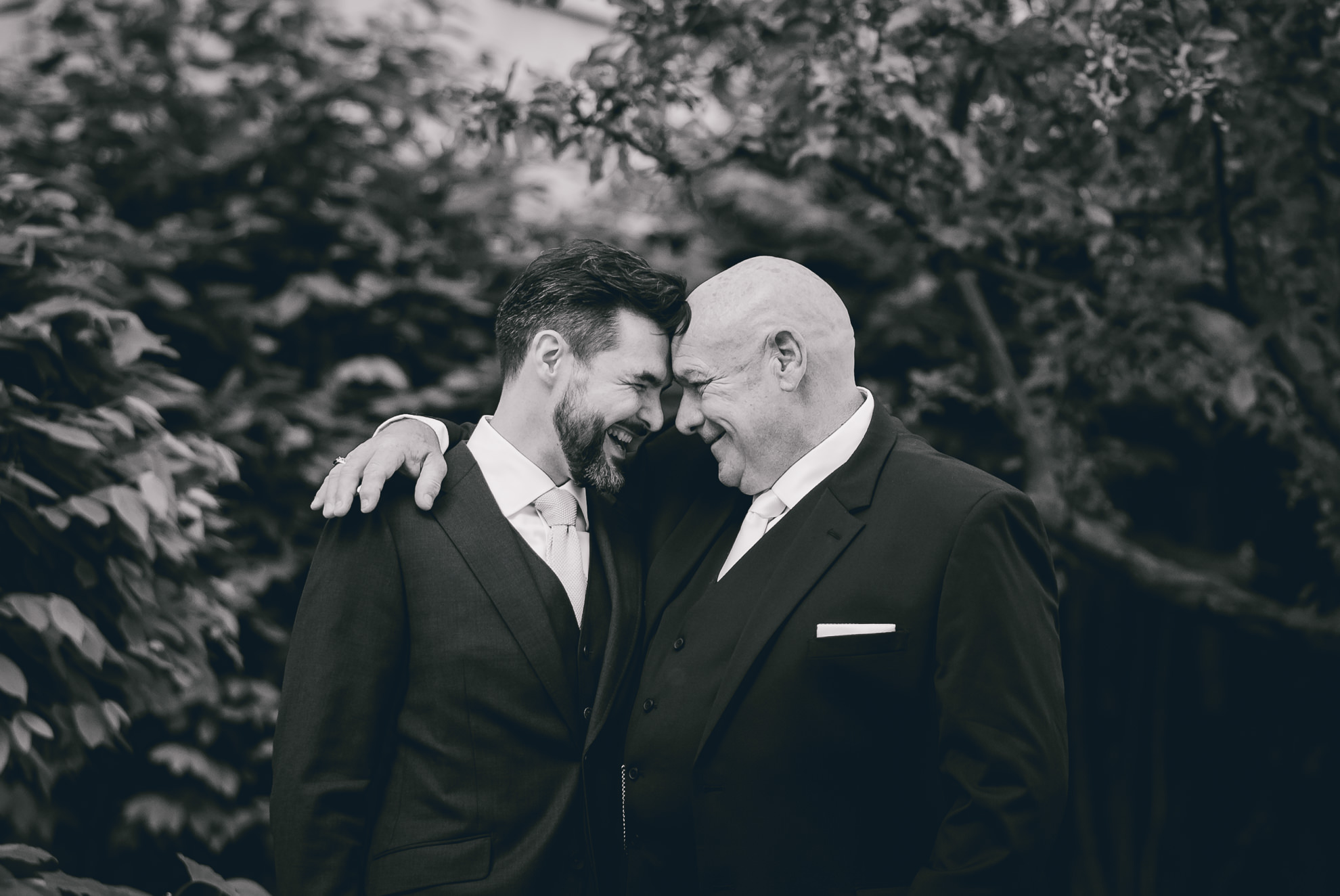 groom and dad share a moment while touching foreheads in Buffalo, NY