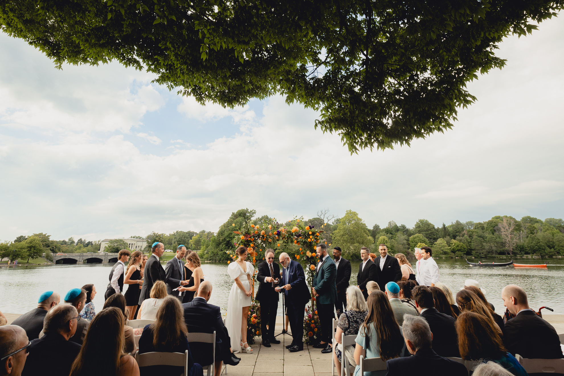 family members read seven blessings during wedding ceremony in front of Hoyt Lake at Delaware Park