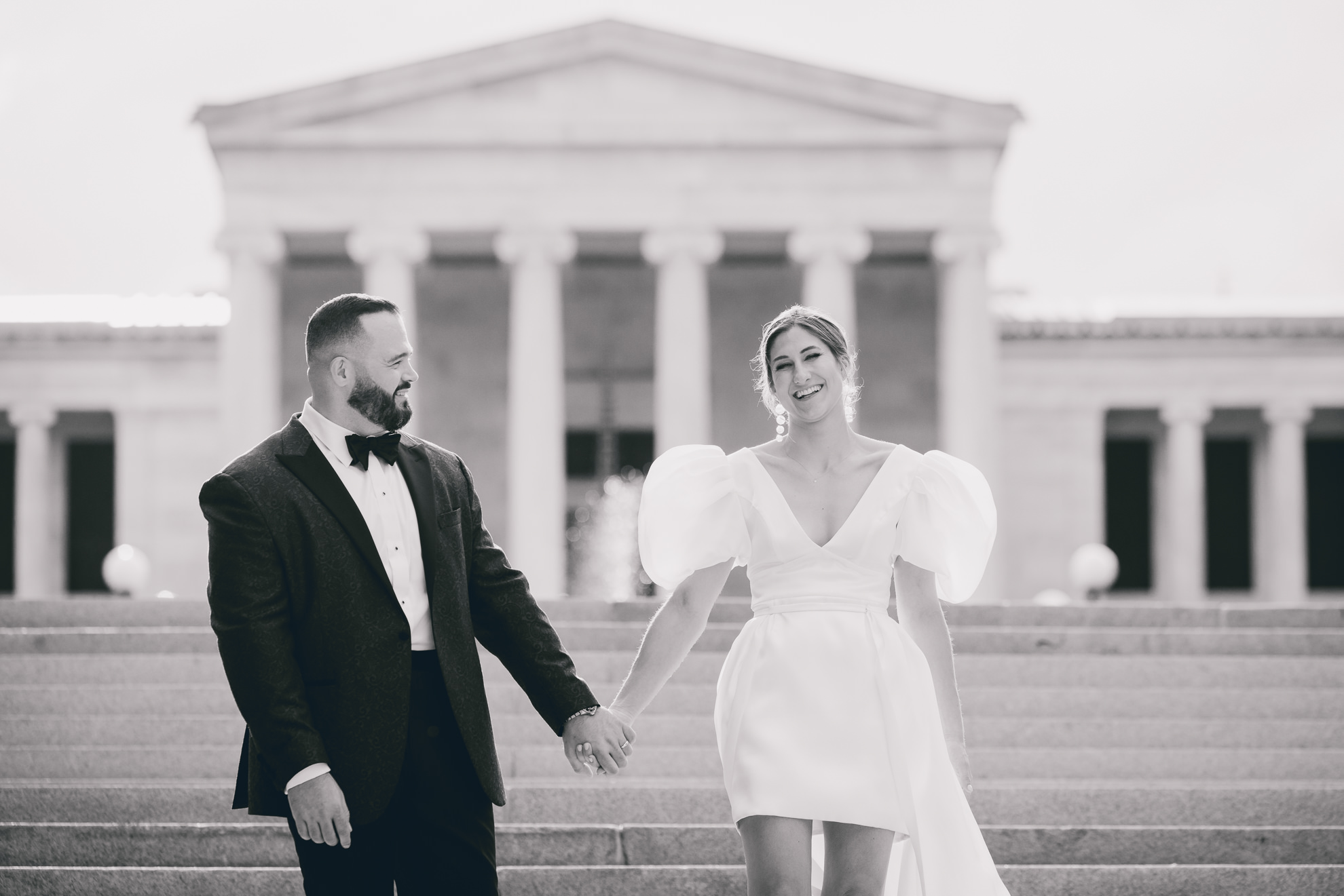 bride and groom pose for wedding portraits in front of AKG in Buffalo, NY