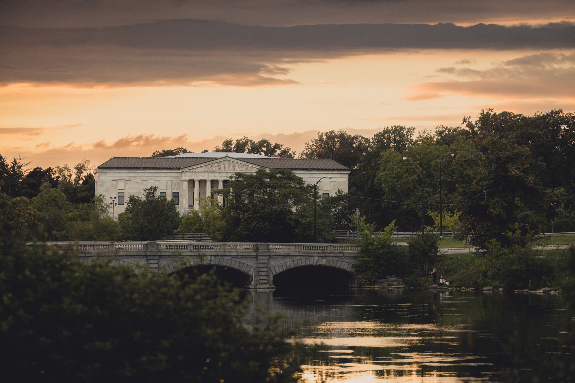 Buffalo history museum pictured beyond Hoyt Lake during sunset from the Terrace at Marcy Casino