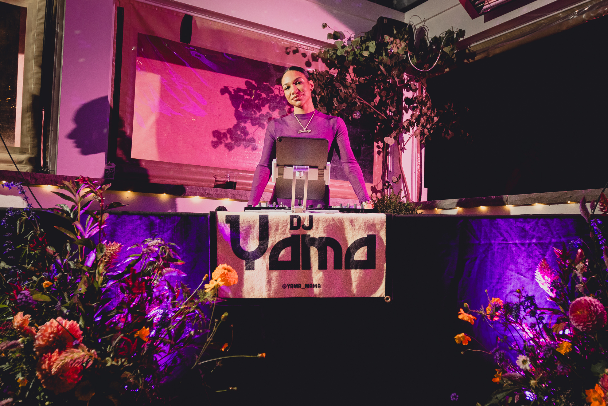 dj Yama poses behind table at wedding in Buffalo, NY