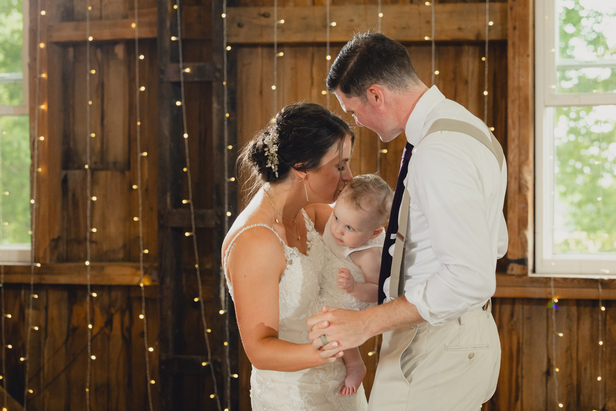 bride groom and baby dance during wedding reception at The Gallagher Barn in Medina, NY