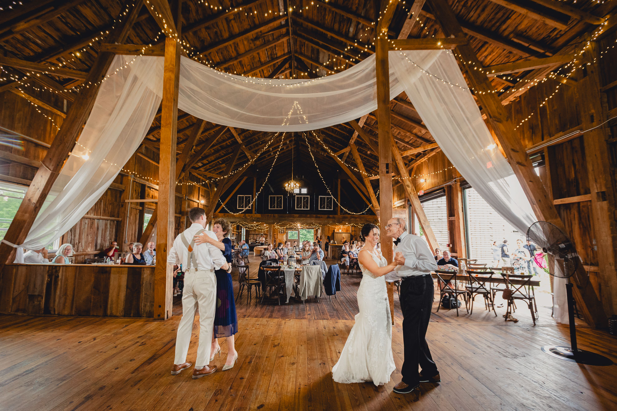 bride and groom dance with parents during wedding reception at The Gallagher Barn in Medina, NY