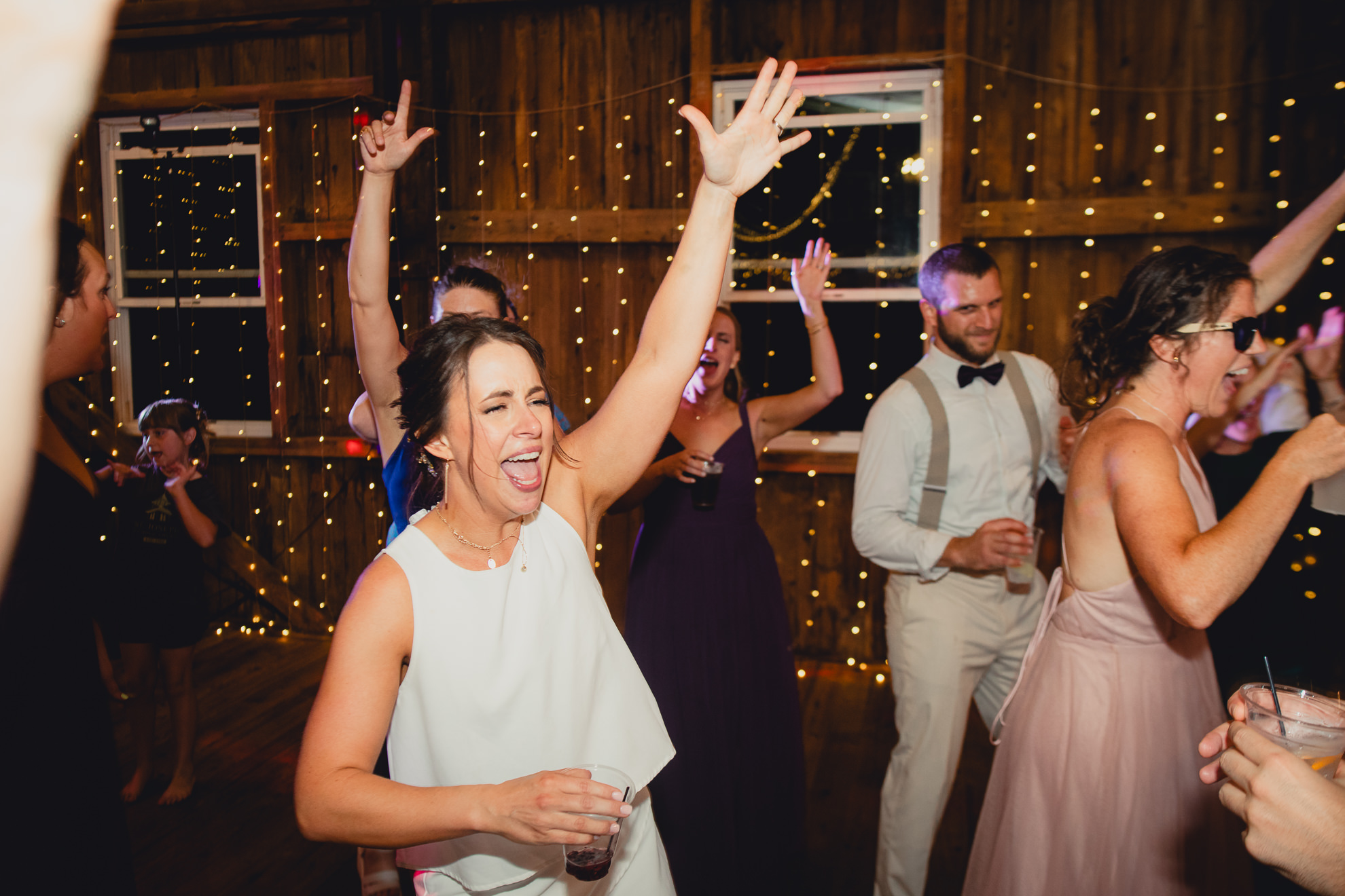 guests dance during wedding reception at The Gallagher Barn in Medina, NY