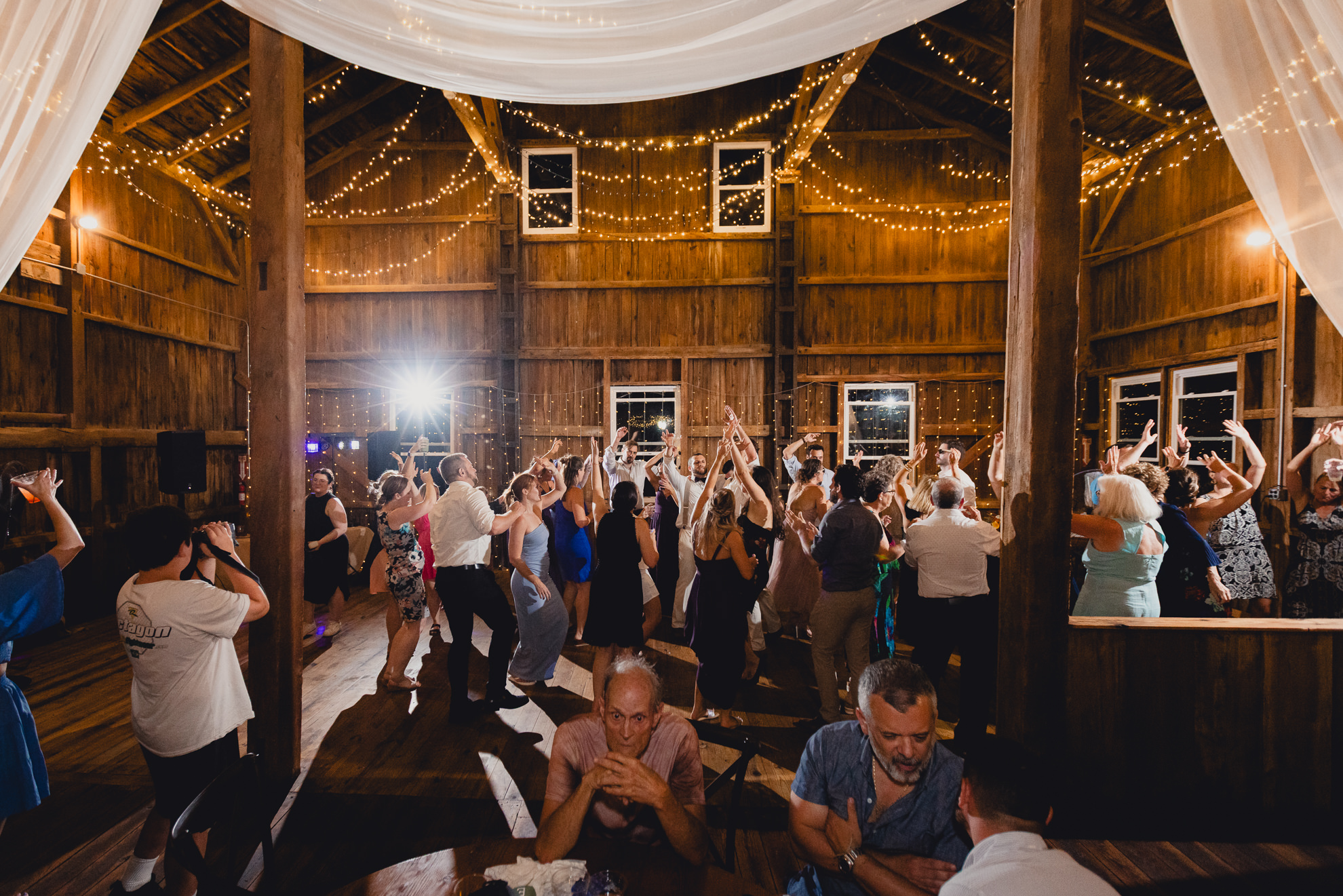 guests dance during wedding reception at The Gallagher Barn in Medina, NY