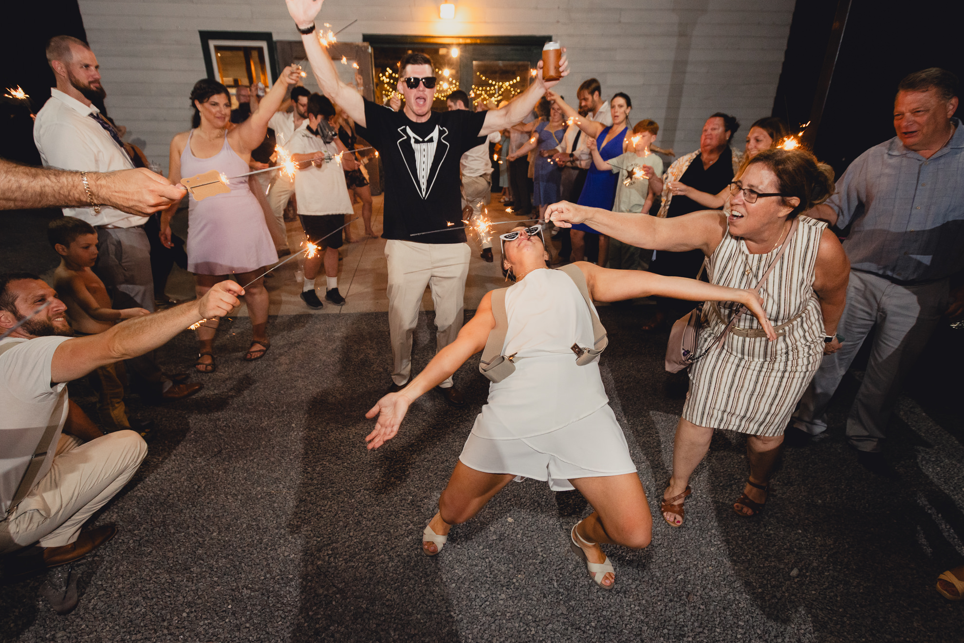 bride and groom walk through sparkler exit after wedding reception at The Gallagher Barn in Medina, NY