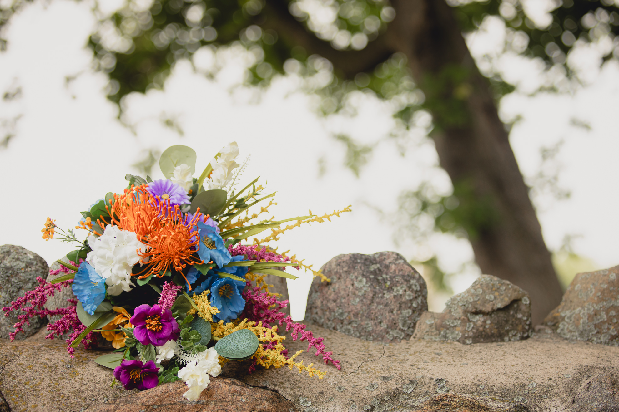 wedding bouquet sits on stone ledge at The Gallagher Barn