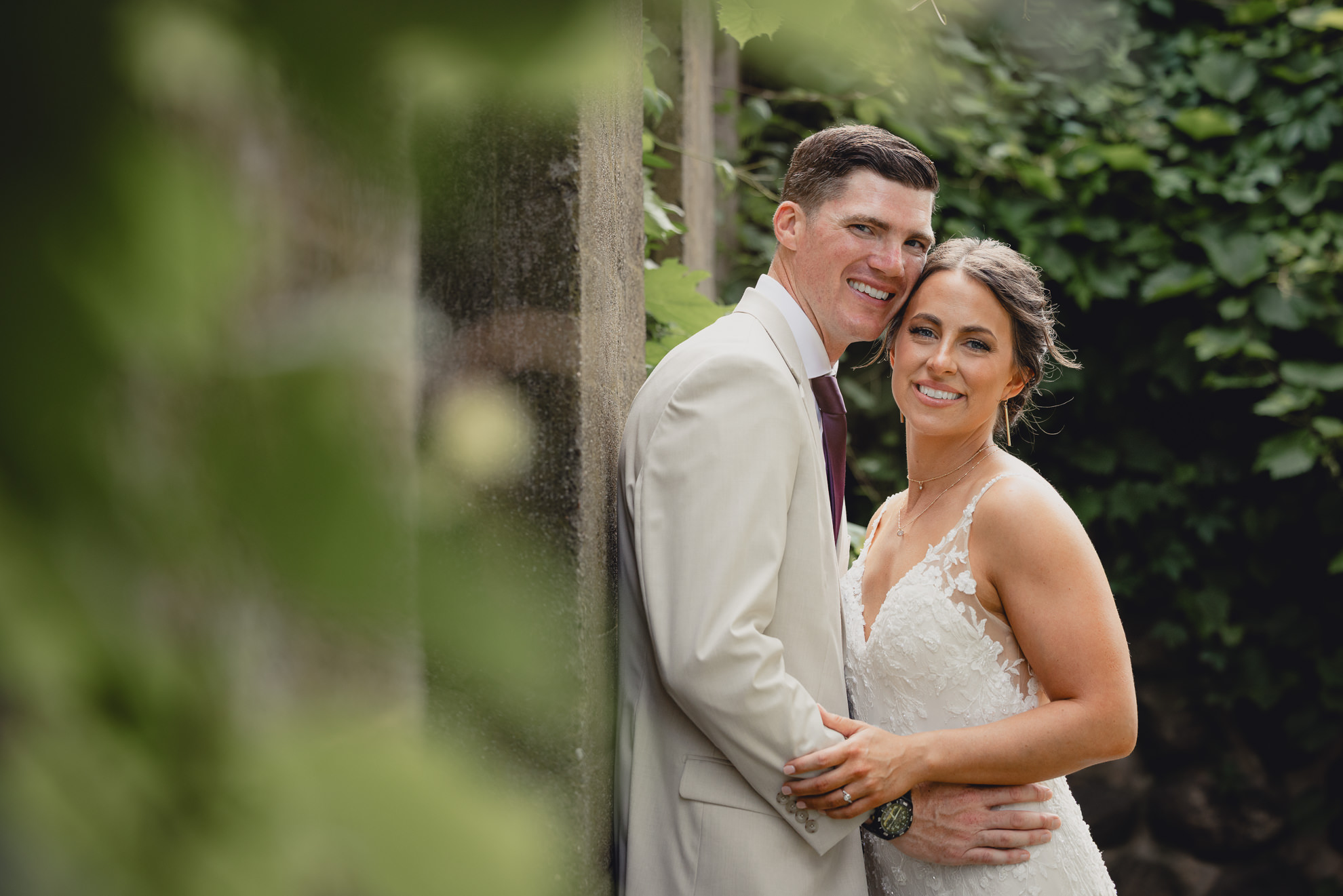 bride and groom pose for wedding photography portrait outside The Gallagher Barn in Medina, NY
