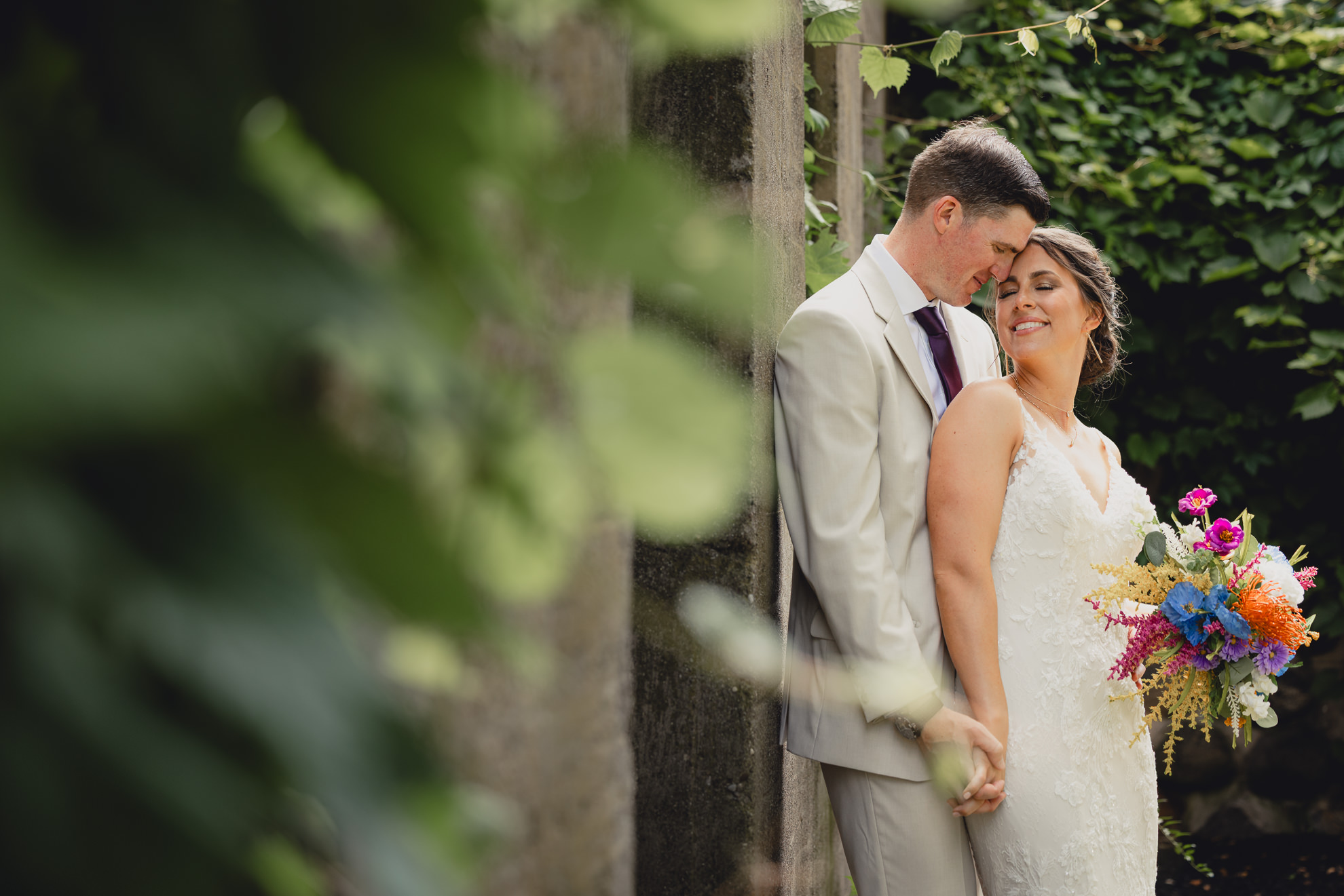 bride and groom pose for wedding photography portrait outside The Gallagher Barn in Medina, NY