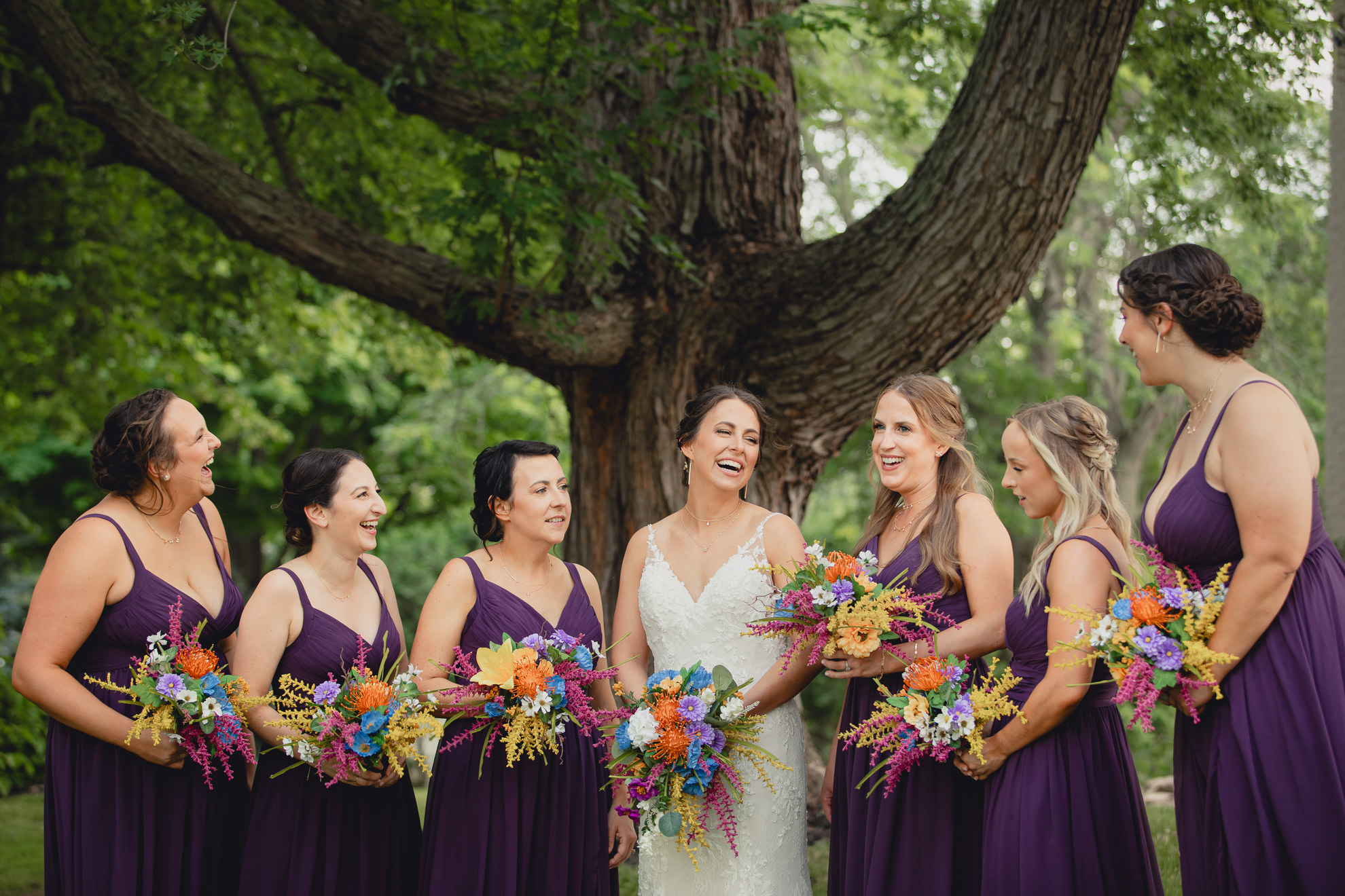 bridesmaids pose for portrait outside historic house at The Gallagher Barn in Medina, NY