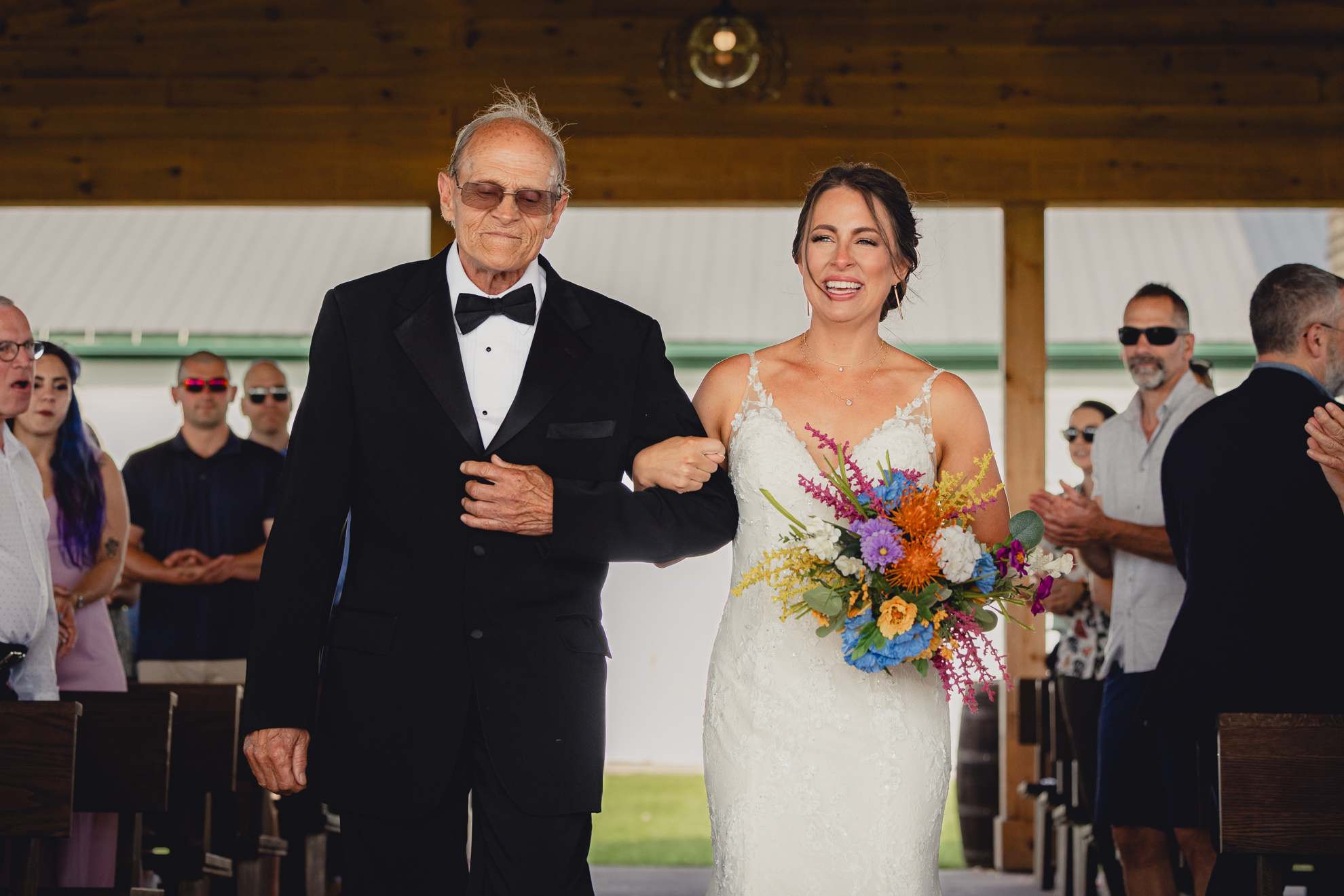 dad walks bride down aisle during wedding ceremony at The Gallagher Barn in Medina, NY