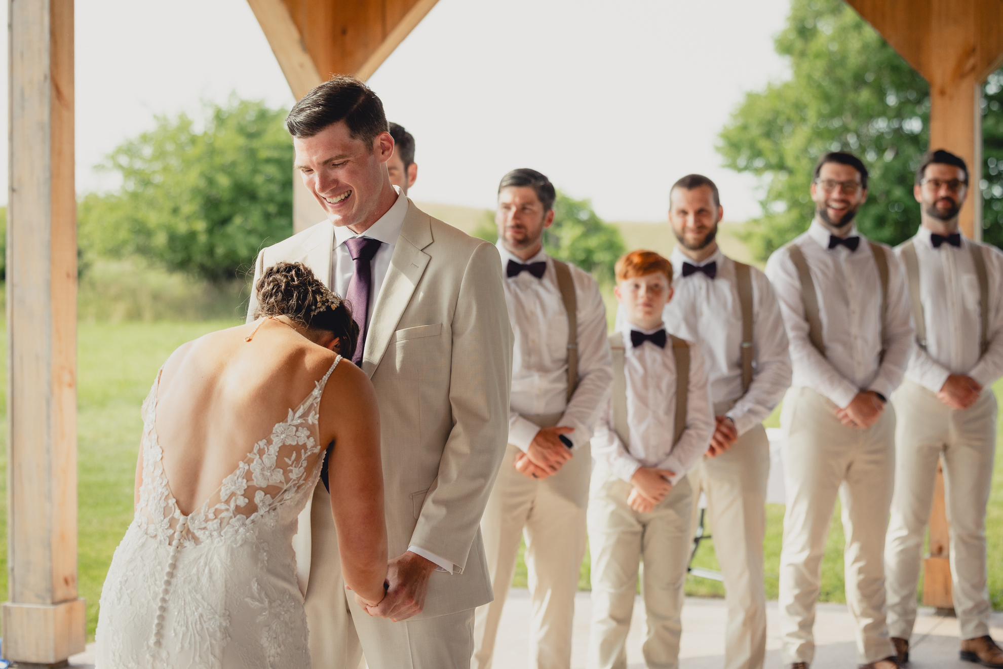 groom laughs during wedding ceremony at The Gallagher Barn in Medina, NY