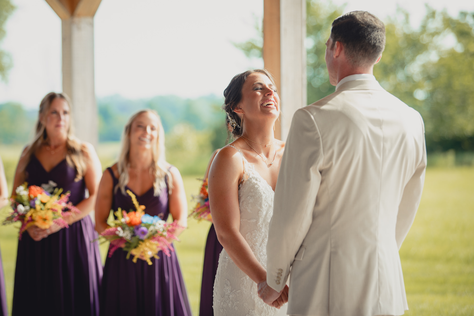 bride laughs during wedding ceremony at The Gallagher Barn in Medina, NY