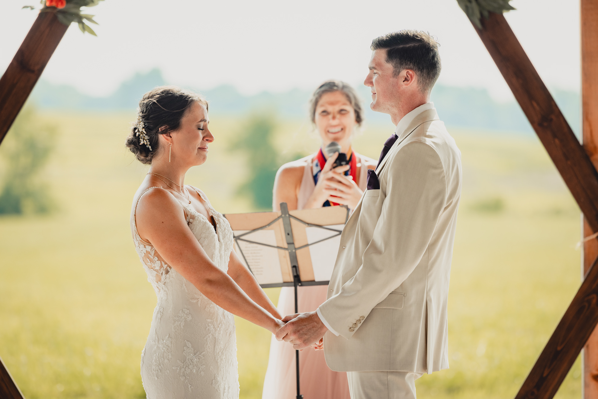 bride cries during wedding ceremony at The Gallagher Barn in Medina, NY