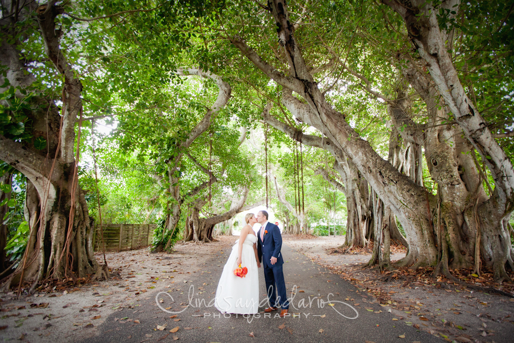 bride and groom kiss under banyan trees after destination wedding ceremony on Gasparilla Island Boca Grande, FL