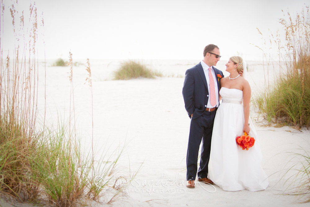 bride and groom smile at each other on beach after destination wedding ceremony on Gasparilla Island Boca Grande, FL