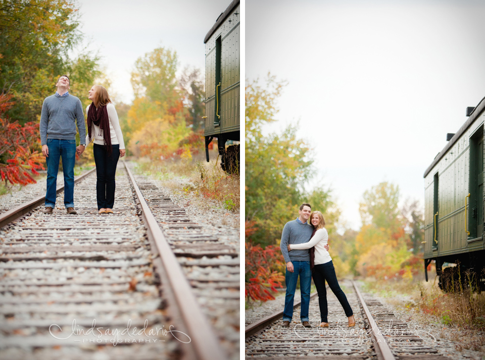 couple laughs on train tracks during their fall during engagement session near Buffalo, NY