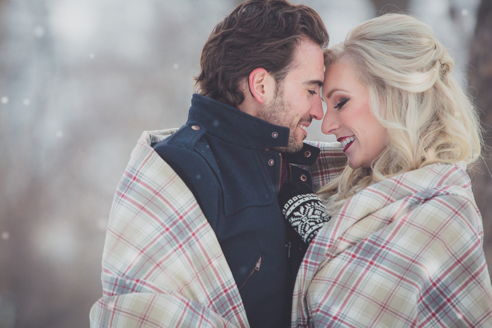 wedding engagement photography of couple wrapped in blanketat Delaware Park in Buffalo, NY