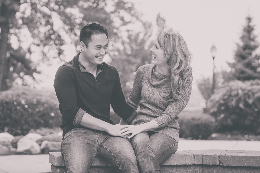 Niagara University Alumni laugh on bench during their wedding engagement photography session