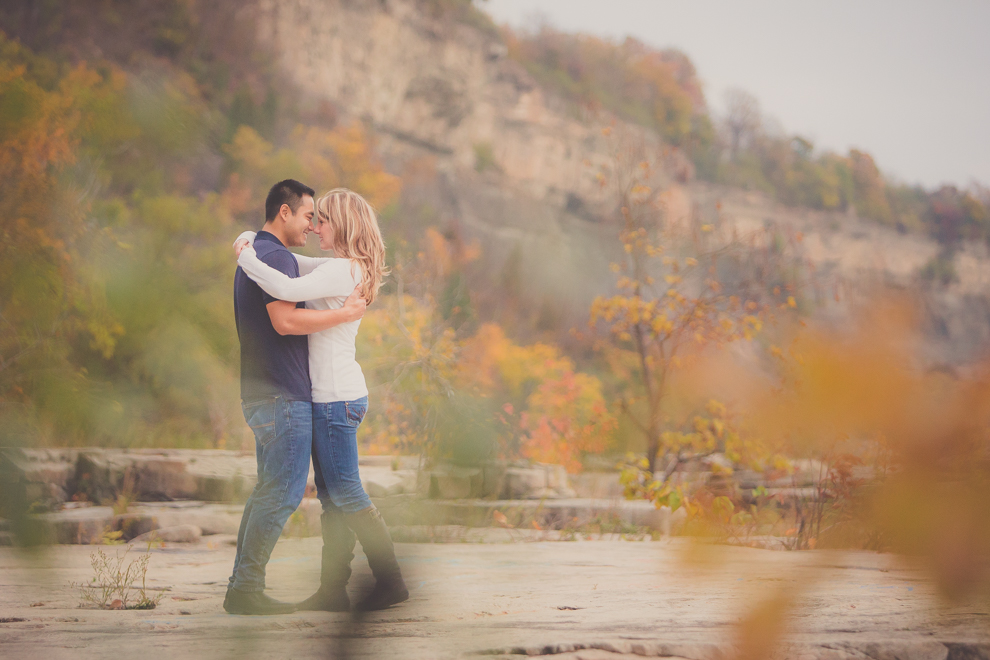 Bride and groom hug along path next to Niagara River in Whirlpool / Devil's Hole State Park during their wedding engagement photography session in Niagara Falls, NY