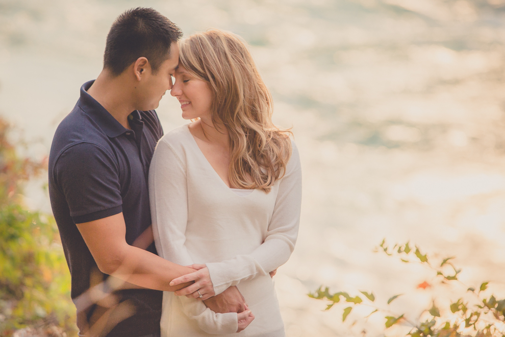Bride and groom snuggle along path next to Niagara River in Whirlpool / Devil's Hole State Park during their wedding engagement photography session in Niagara Falls, NY