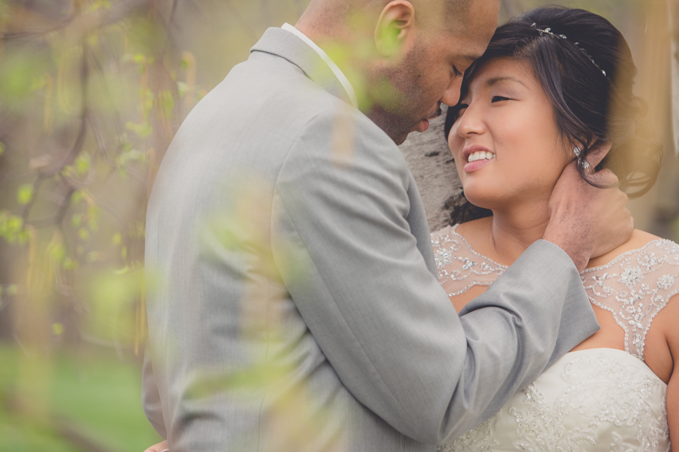 bride and groom look at each other in garden at outdoor wedding ceremony venue, the Avanti Mansion, near Buffalo, NY