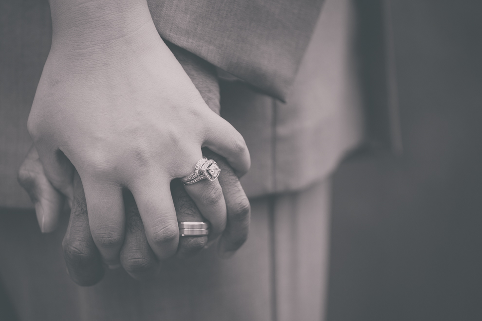bride and groom hold hands in garden at outdoor wedding ceremony venue, the Avanti Mansion, near Buffalo, NY