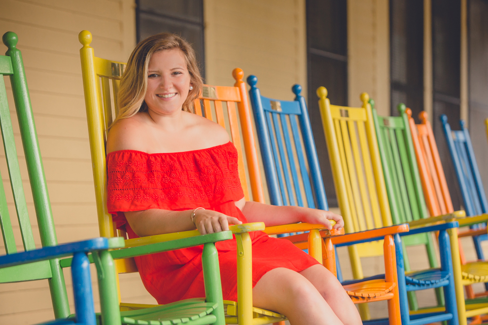 Maple Grove Senior Portrait of Alli on rockers at Hotel Lenhart by Lake Chautauqua in Bemus Point, NY
