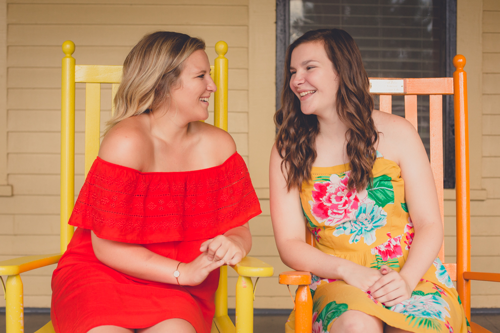 Maple Grove Senior Portrait of Alli and sister on rockers at Hotel Lenhart by Lake Chautauqua in Bemus Point, NY