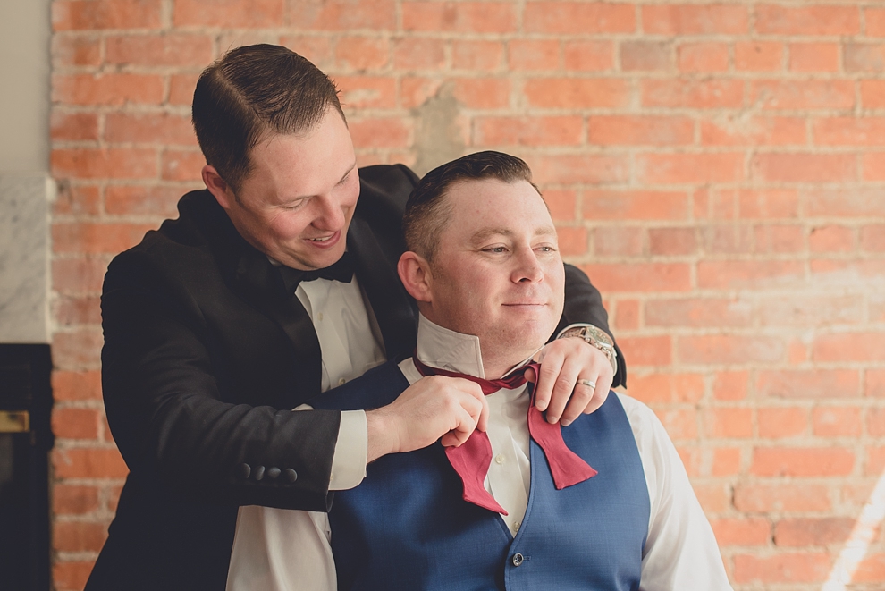 groom prepares for wedding in hotel room at Webb Lofts on Pearl St. in Buffalo, NY