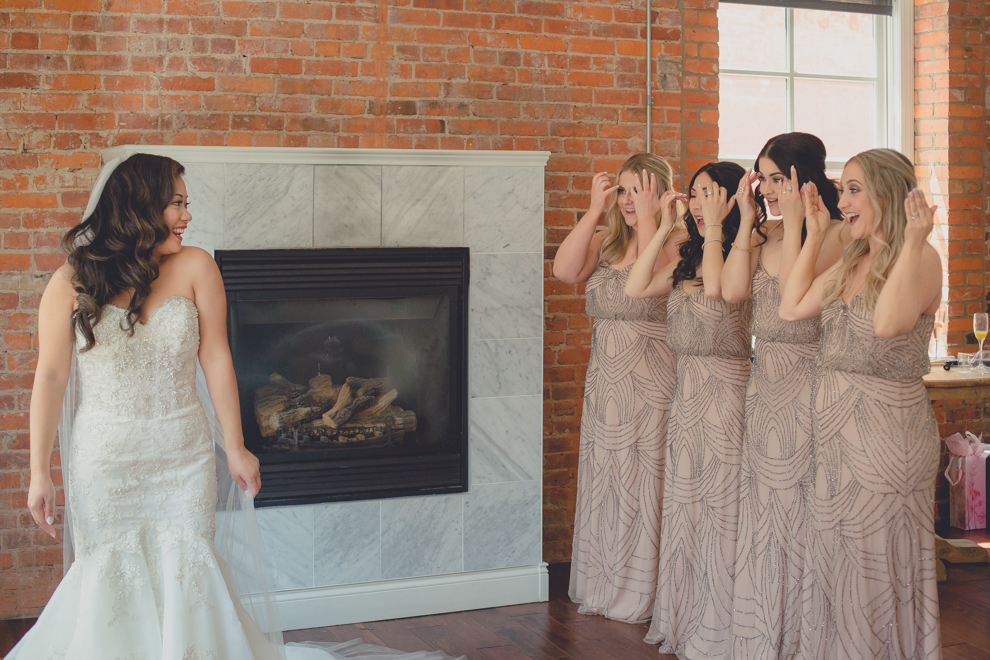 bridesmaids see bride for first time atwhimsical urban woodland themed wedding photography in buffalo, ny at webb lofts, lafayette hotel, pearl st brewery