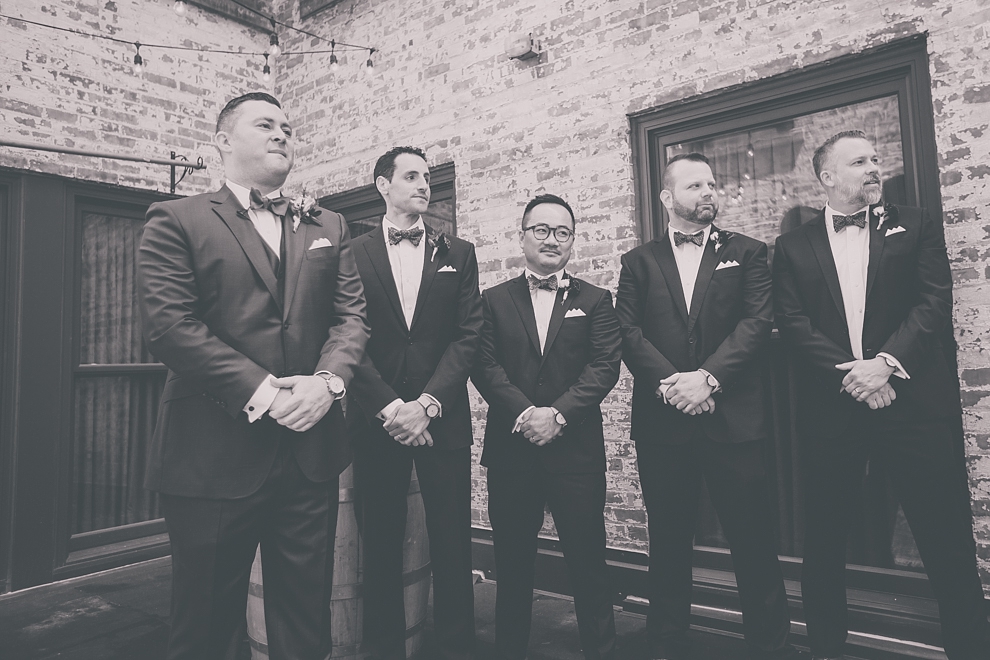 groom waits for bride before whimsical urban woodland themed wedding ceremony at webb lofts, lafayette hotel, pearl st brewery in Buffalo, NY