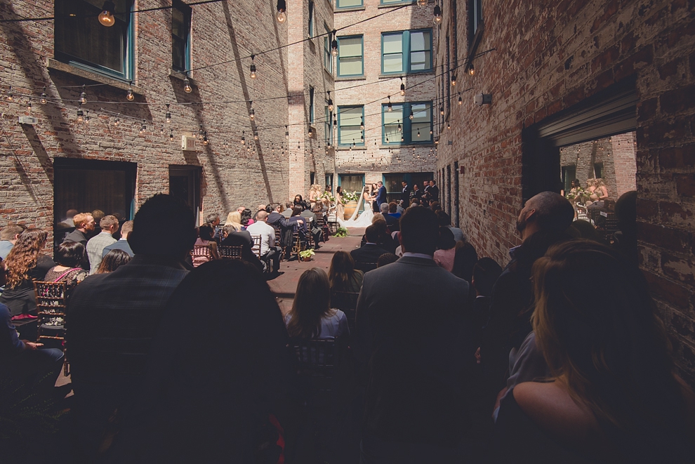 bride and groom cheer after whimsical urban woodland themed wedding ceremony at webb lofts, lafayette hotel, pearl st brewery in Buffalo, NY