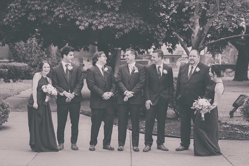 groom and groomsmen laugh during wedding at St. Joseph's University Parish Church in Buffalo, NY