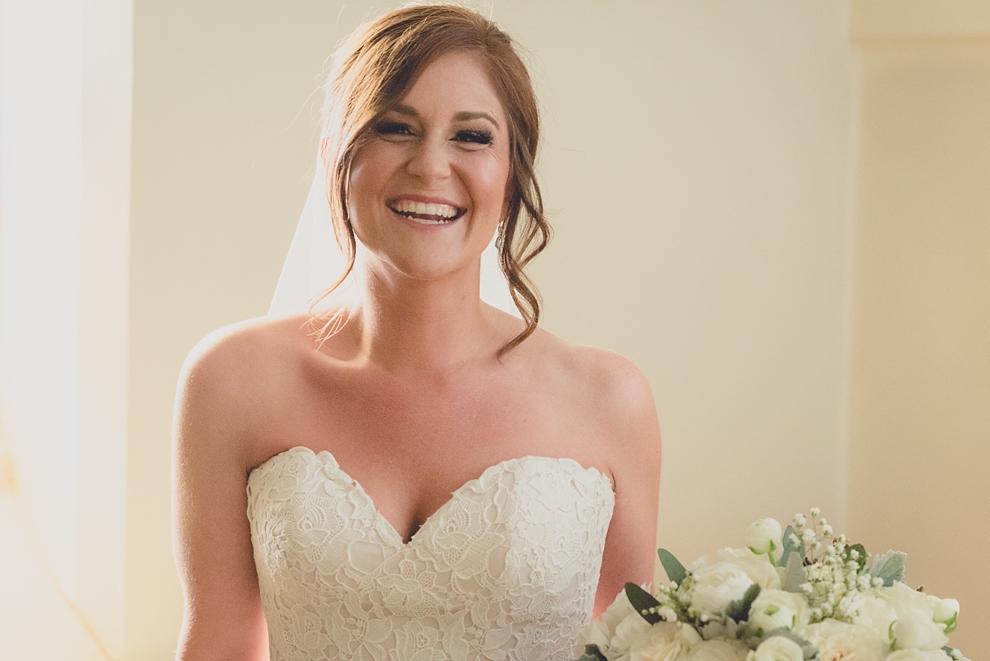 bride smiles before ceremony during wedding at St. Joseph's University Parish Church in Buffalo, NY