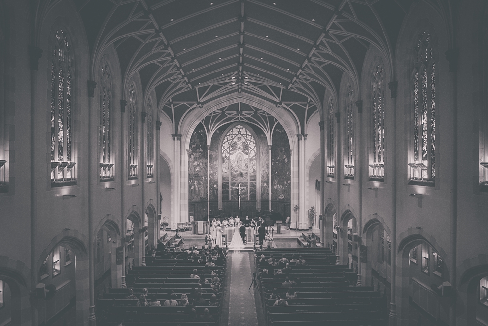  bride and groom exchange vowsduring wedding at St. Joseph's University Parish Church in Buffalo, NY